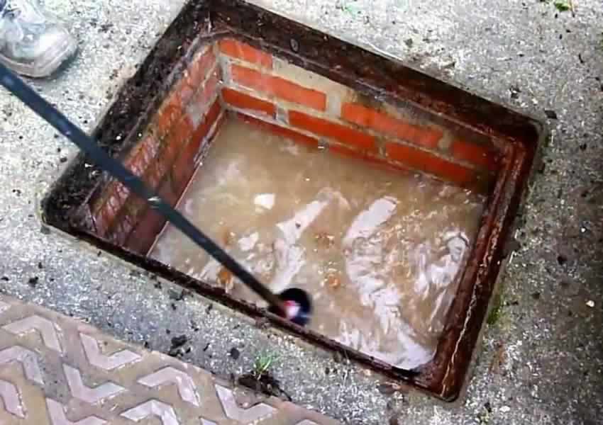 blocked drain manhole cover off